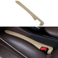 Beige car seat gap filler strip with red latch for console gap.