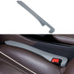 Gray car seat gap filler strip with red latch for console gap.