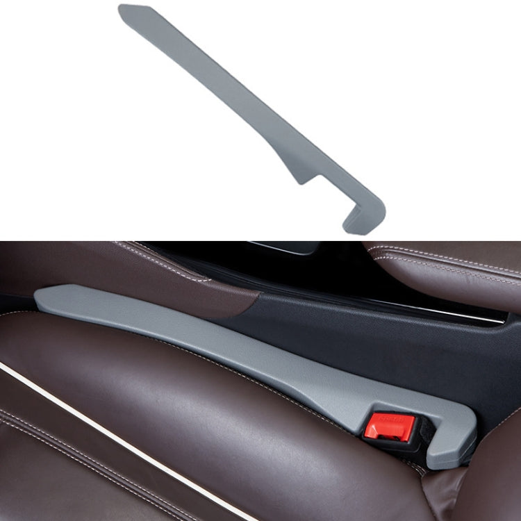 Gray car seat gap filler strip with red latch for console gap.