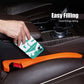 Orange car seat gap filler strip being placed by hand along seat console gap.