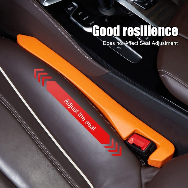 Car seat gap plug in orange with red latch beside center console