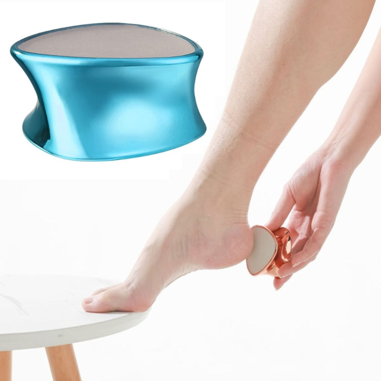 Blue handheld foot peeling grinder near bare foot, textured grinding head