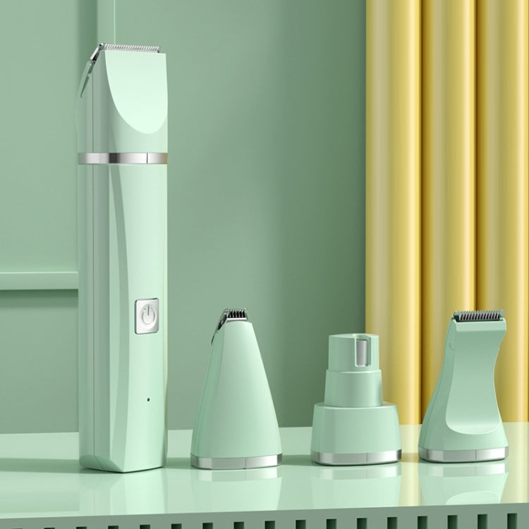 Green electric pet hair clipper with several attachment heads and base stack
