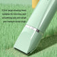 Green electric pet clipper with large shaving head on grass background