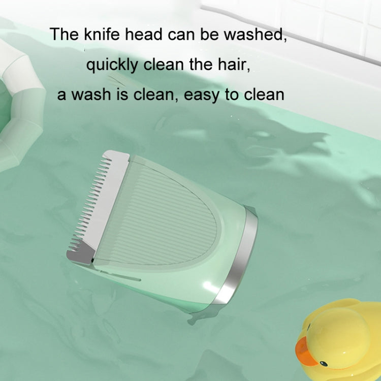 Green pet hair clipper shaver head resting on tray, with wash-ready blade