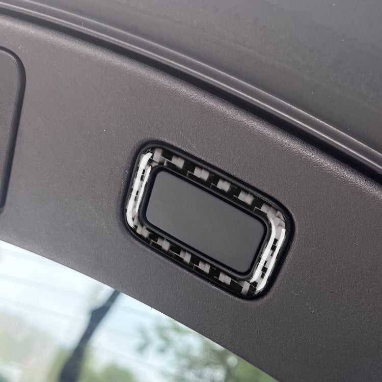 Rectangular trunk button sticker bezel installed on car dashboard panel