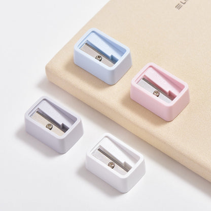 Set of mini pencil sharpeners, blue and pink plastic bodies with exposed cutting blades