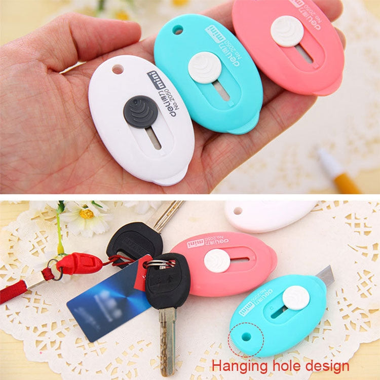 Blue and white mini utility knives in hand; pink and black key-ring versions below.