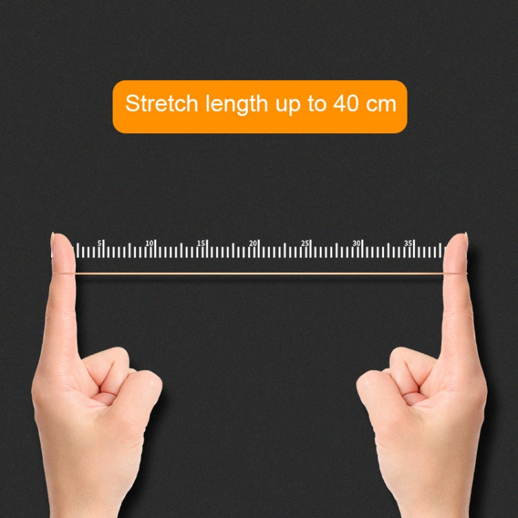 Yellow rubber band stretched across a ruler for length measurement