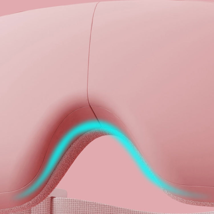 Pink eye massager close-up with glowing blue heating area inside