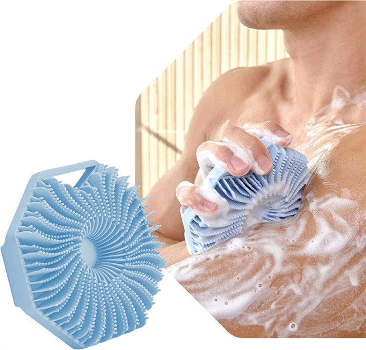 Blue silicone shower scrubber brush with flexible fins held against soapy skin