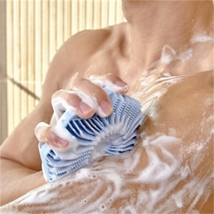 Blue silicone shower scrubber brush with circular fins scrubbing soapy skin