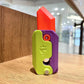 Purple and green gravity decompress fidget toy with red top and circular screw