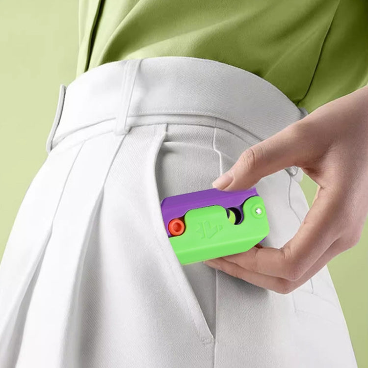 Green gravity decompress toy held against white pants pocket