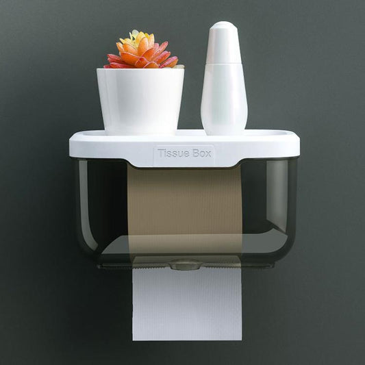 Wall-mounted tissue box with transparent dark base and white lid, front paper outlet