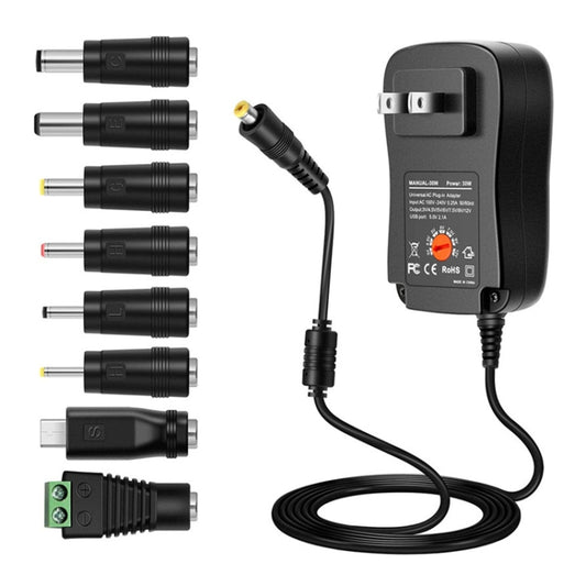 Black power adapter with adjustable output dial, DC barrel tips, and cable bundle