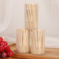 Three bamboo two-tine dessert fork cans on a surface