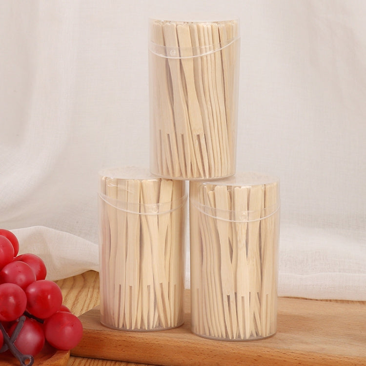Three bamboo two-tine dessert fork cans on a surface