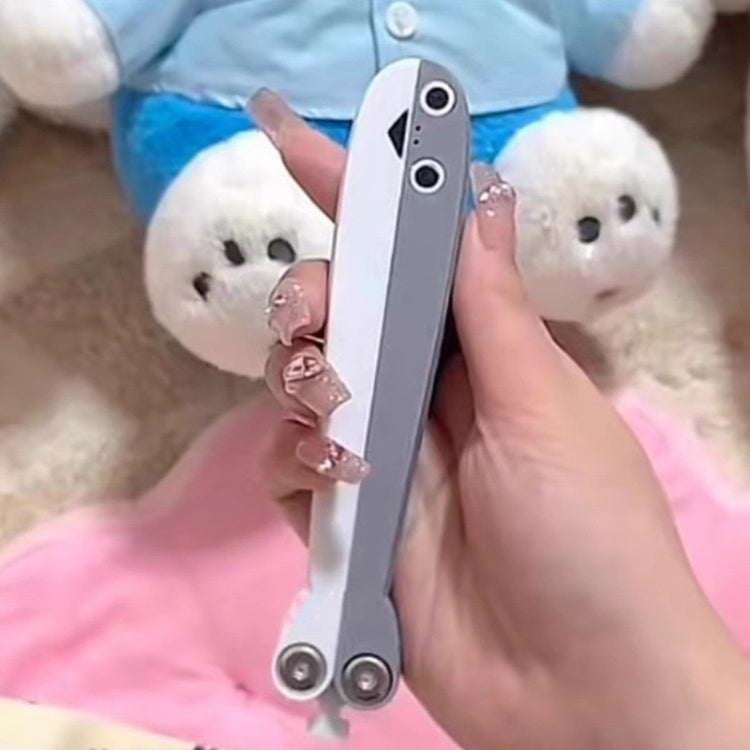 Butterfly knife toy held in hand, gray handle with white blade insert and pivot bolts