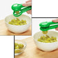 Handheld fruit slicer pressing into sliced fruit inside a bowl