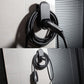 EV charger wall bracket holding plug and cable near exterior wall