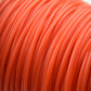 Close-up of red orange nylon trimmer line strands.