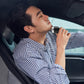 Handheld rechargeable electric shaver in use on a person’s face