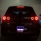 Rear view of car with glowing purple solar LED warning light in the license area