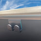 Gray glove box hook installed on dashboard edge with two openings