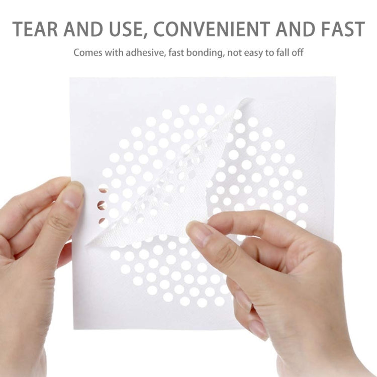 Hands placing a disposable non-woven drain filter sticker over perforated surface