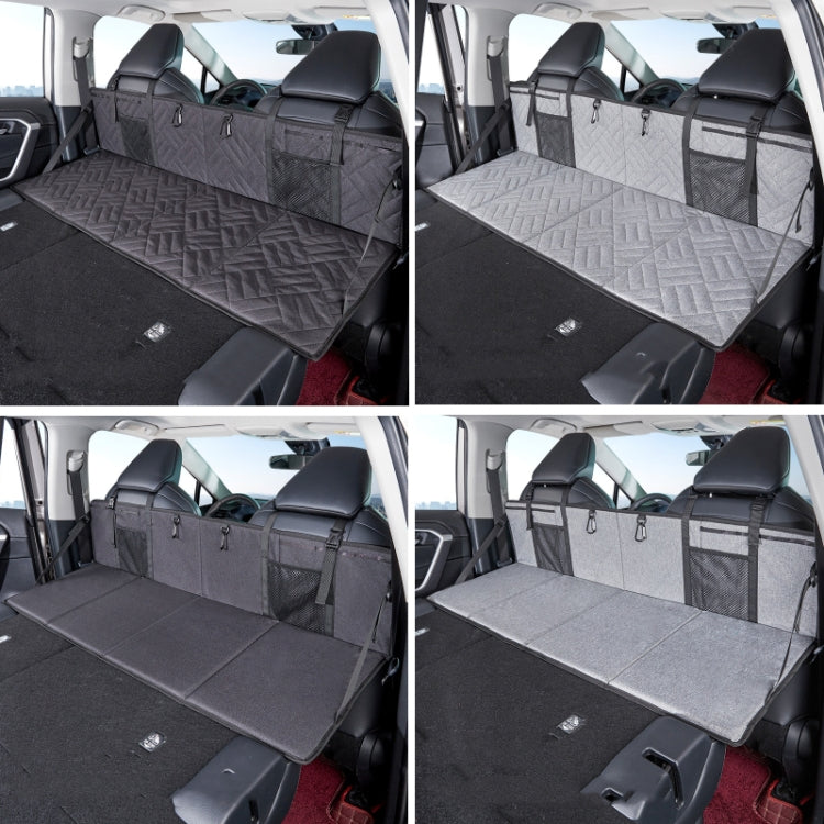 Folding car camping bed extension board with quilted surface and gray storage organizers