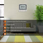Wall-mounted digital perpetual calendar alarm clock on a light brick wall