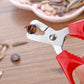 Red-handled nut sheller with pointed metal jaws and rivet hinge