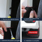 Hands installing a black mud flap with red trim; mounting holes and screws shown