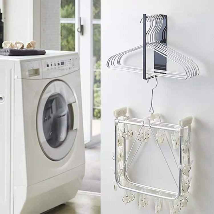 Wall-mounted metal clothes hanger storage rack with multiple white hangers attached