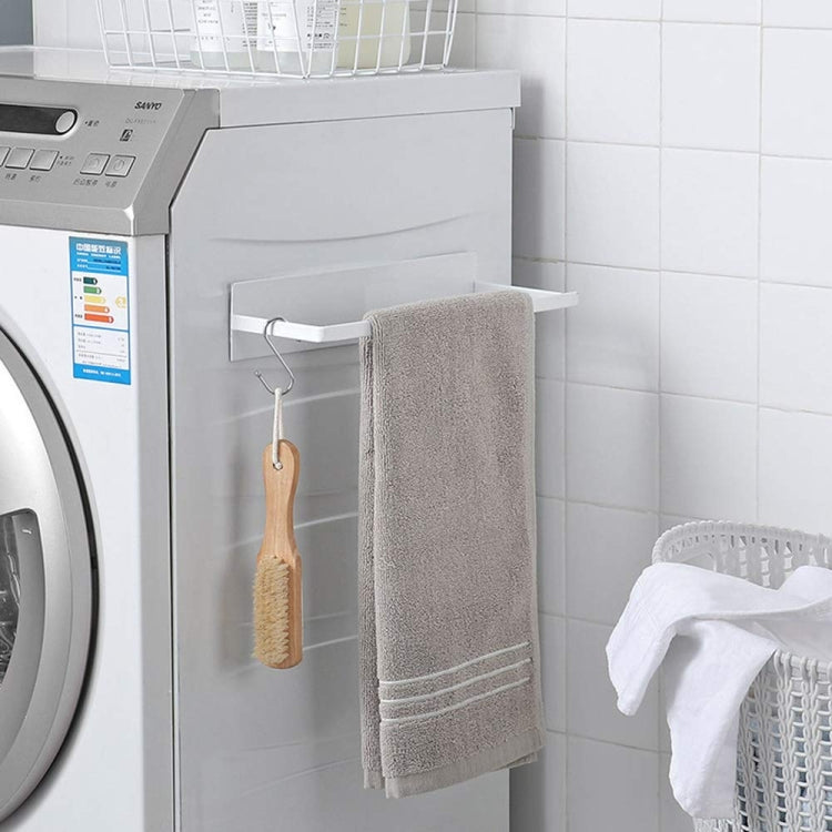 Wall-mounted metal rack with two hooks holding a folded towel on a wall