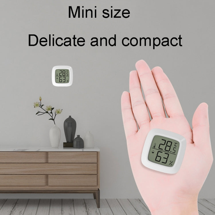 Mini digital temperature and humidity meter in a hand, LCD shows 28.5°C and 63%RH