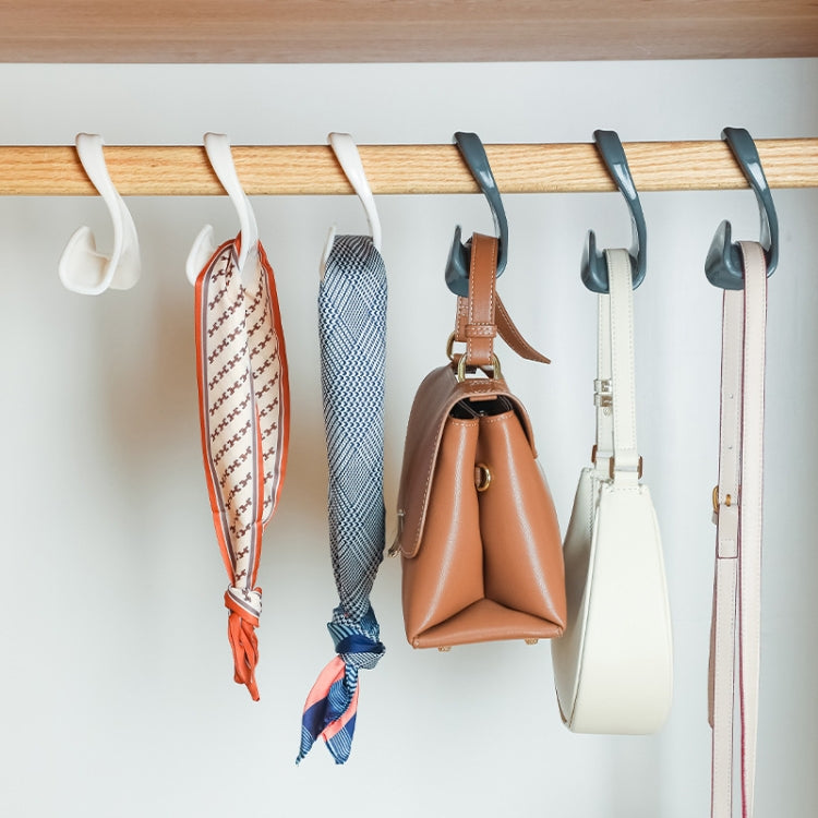 Assorted arched hooks on a rod holding handbags and fabric items for storage