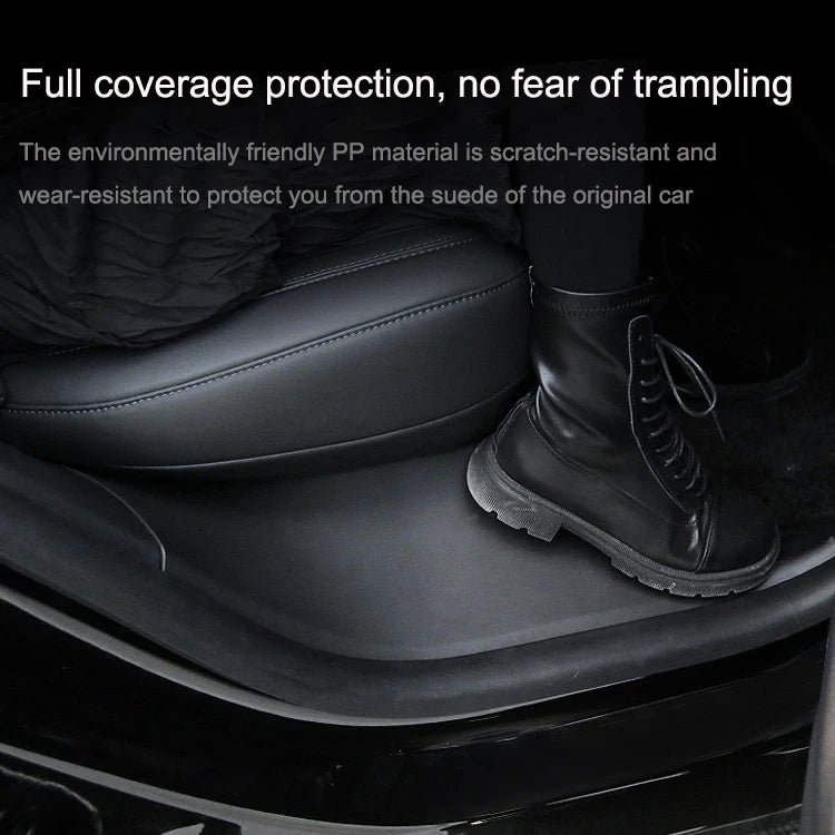 Black door sill protective pad installed to cover kick area near seat