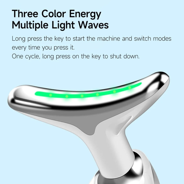 Oval neck beauty instrument with metallic finish and green light strip on handle