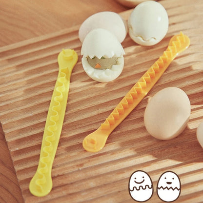 Lace egg cutter molds with wavy teeth, shown with halved boiled eggs
