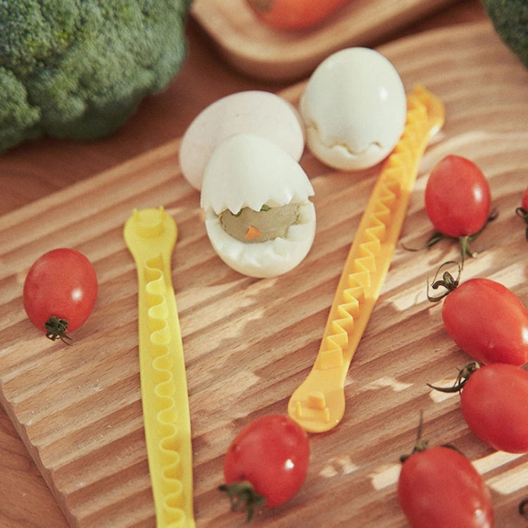 Lace egg cutter molds with shell-shaped eggs and red tomatoes