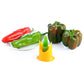Yellow chili corer seed extractor centered among peppers on a plate.