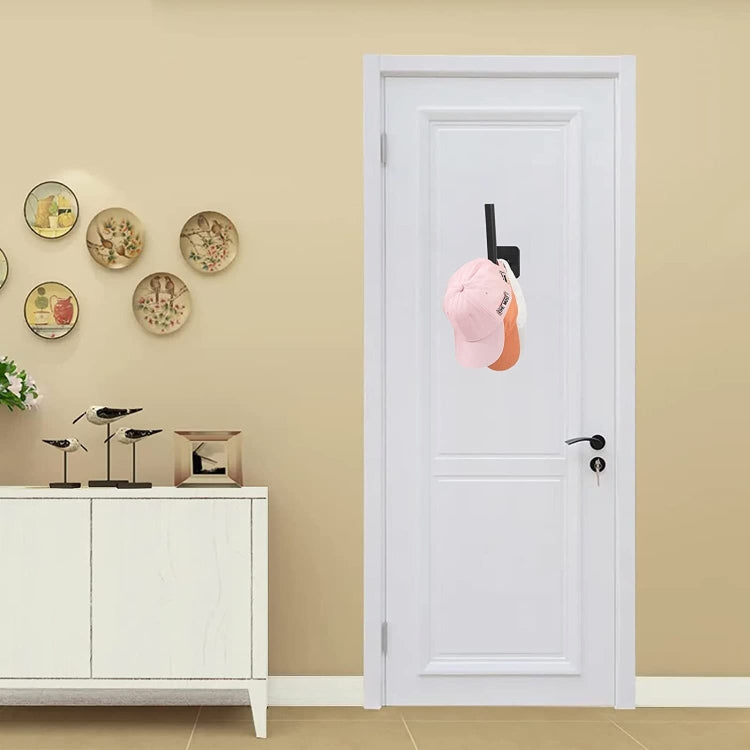 Self-adhesive hat rack wall hook holding a baseball cap