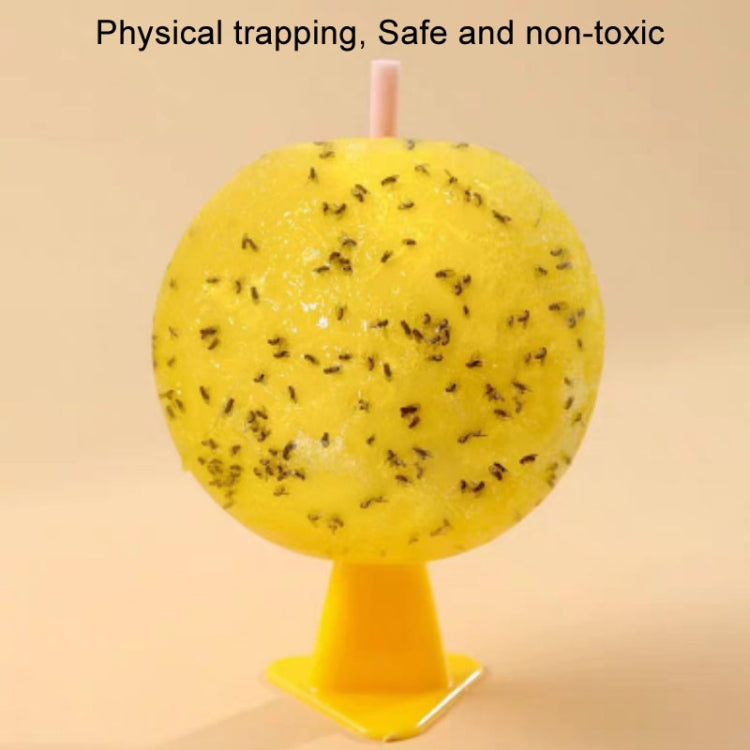 Yellow sticky insect trap ball with trapped insects on sticky surface