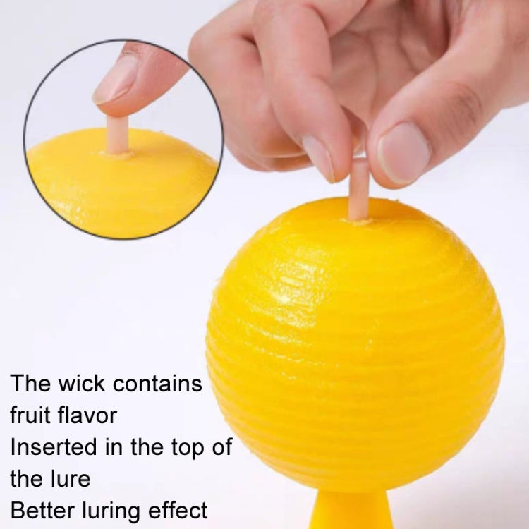 Yellow sticky insect trap ball with top wick, hand placing the lure