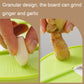 Green grater board with holes, showing ginger and garlic being ground