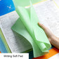 Green non-slip writing soft pad with ruler edge, held over paper by a hand