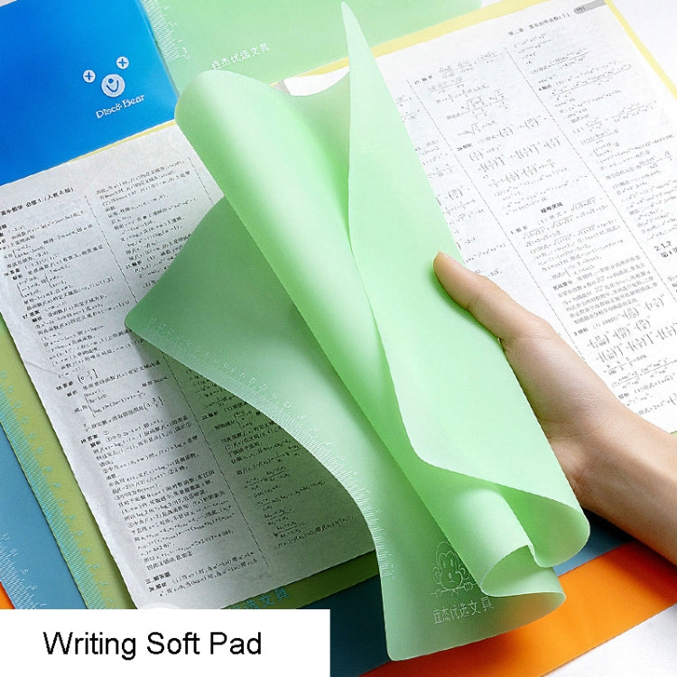 Green non-slip writing soft pad with ruler edge, held over paper by a hand