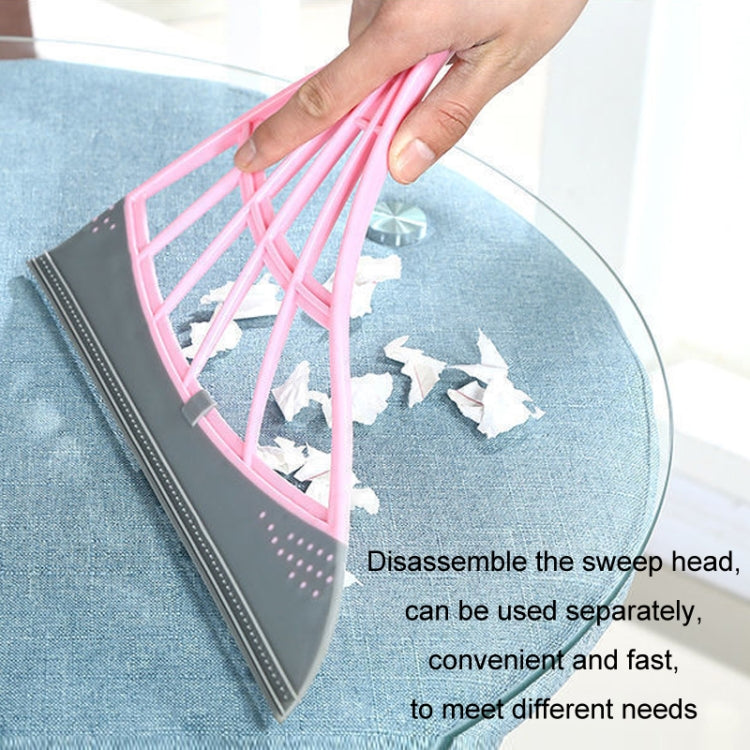 Hair cleaning mop head with pink mesh and gray scraper plate held by hand